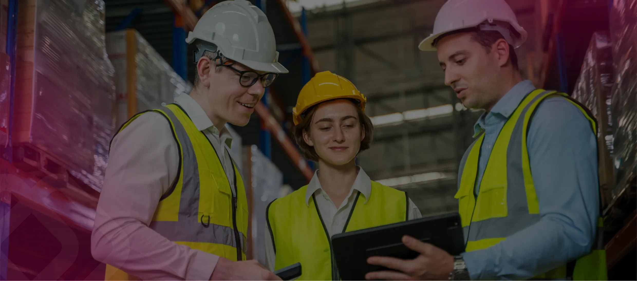 Workers with a tablet in a warehouse