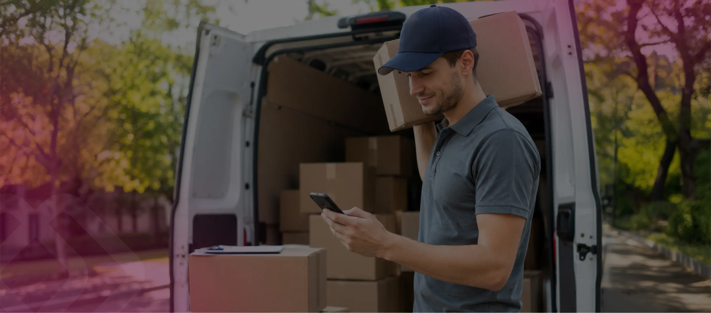 Delivery driver loading boxes into a van