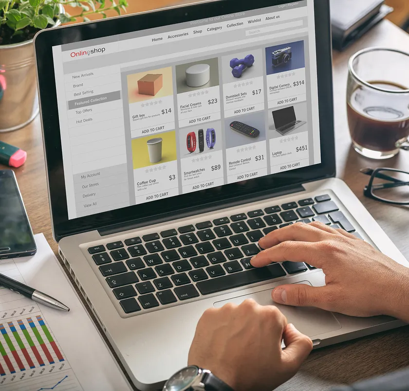 Hands using a laptop showing an online shop