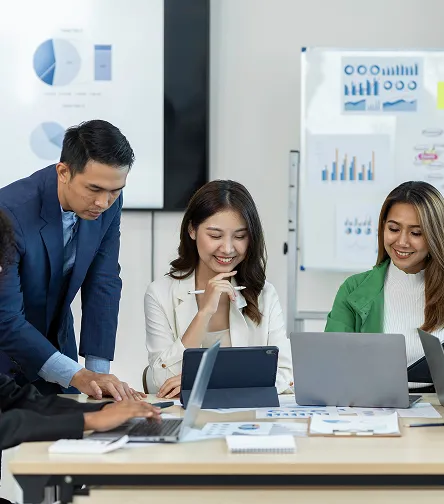 Business team presenting charts by a whiteboard