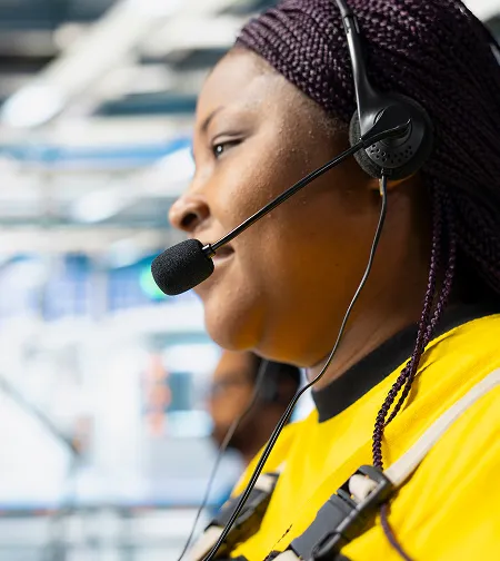 Woman in hi-vis wearing a headset