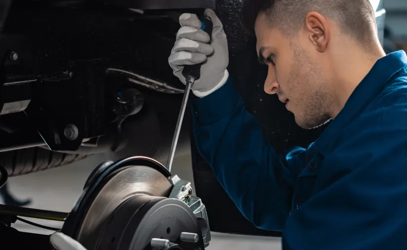 Mechanic working under a vehicle