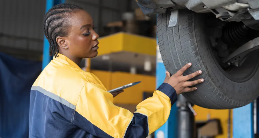 Mechanic inspecting a wheel