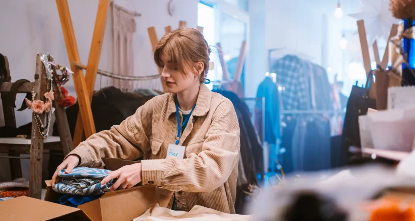 Woman using a card machine in a shop