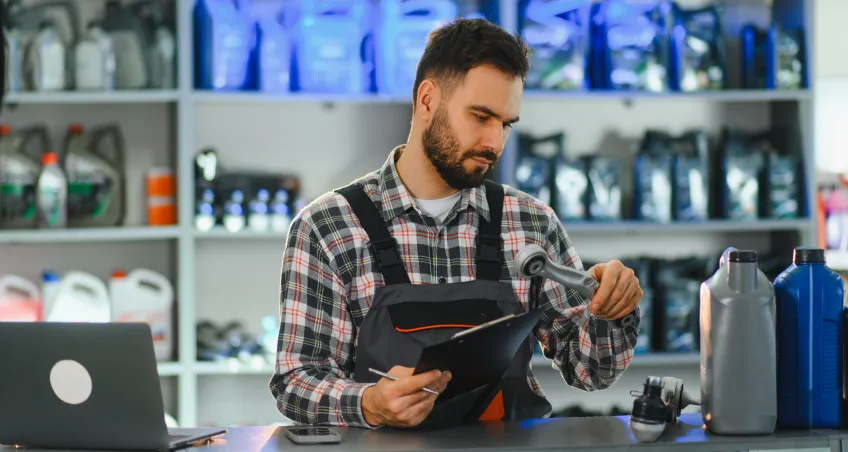 Shopkeeper using a tablet at a retail counter