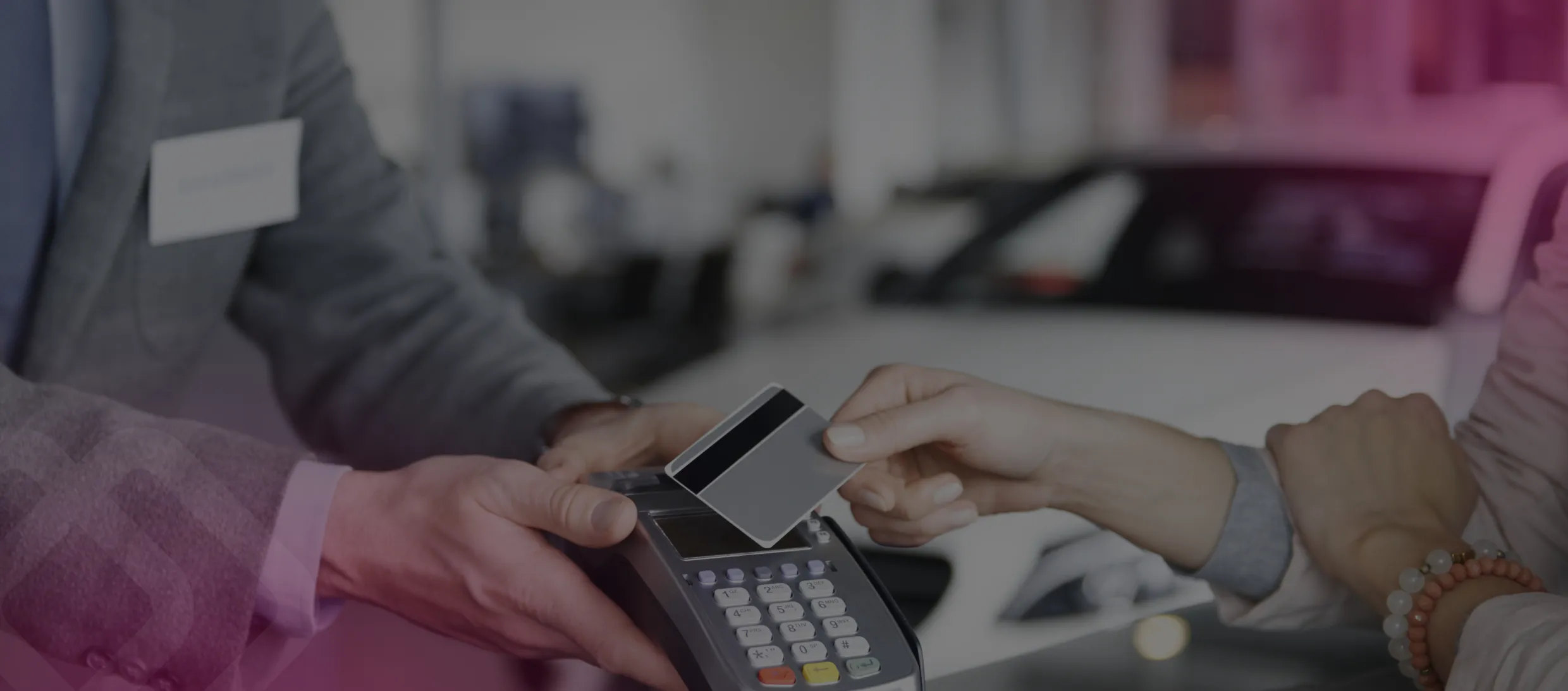 Hands using a calculator and card at a desk