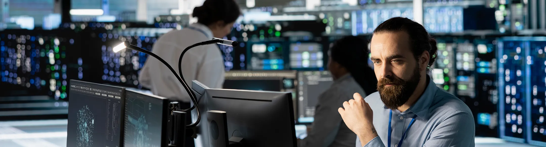 Colleagues analysing data on computer screens