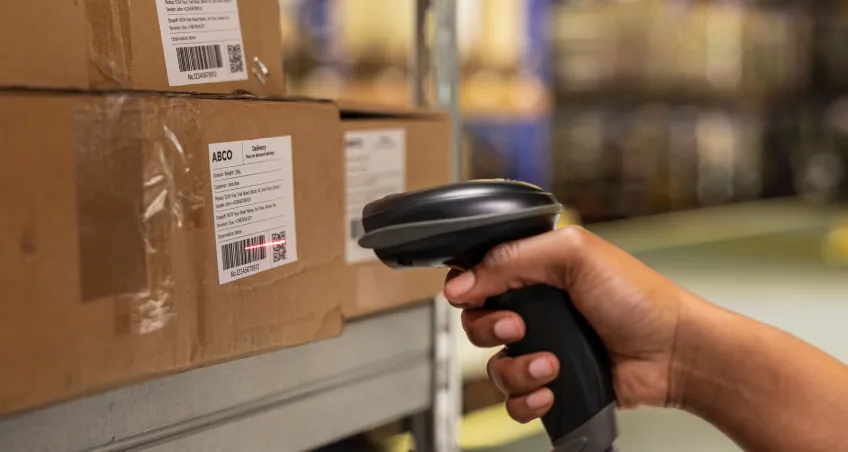 Hand scanning a parcel with a barcode scanner