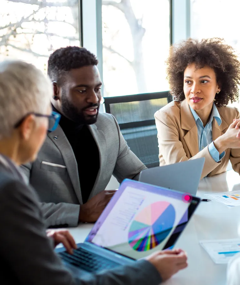 Business team in a meeting with a laptop and charts