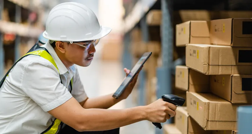 Worker scanning a box with a barcode scanner