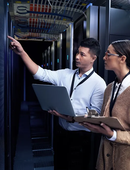 Two IT staff in a server room