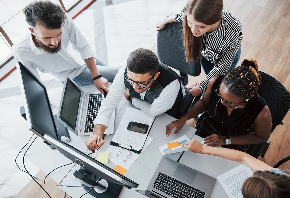 Team collaborating around computers