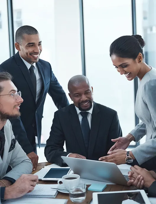 Business team meeting around a laptop