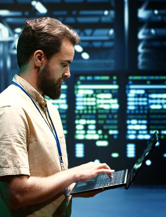 Man using a laptop in a data centre