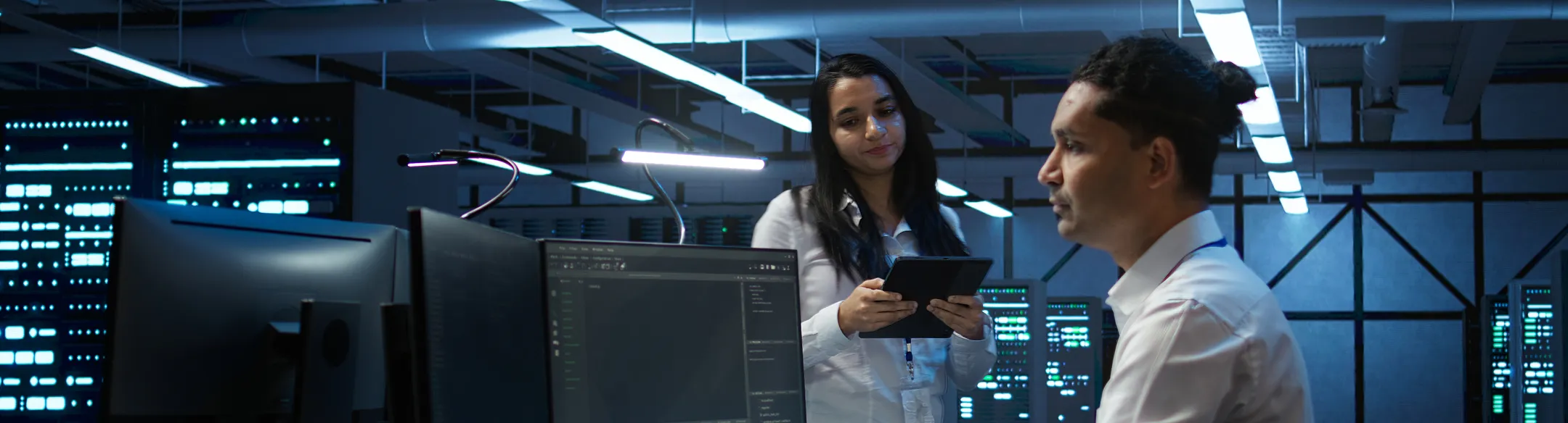 Colleagues working at computers in a control room