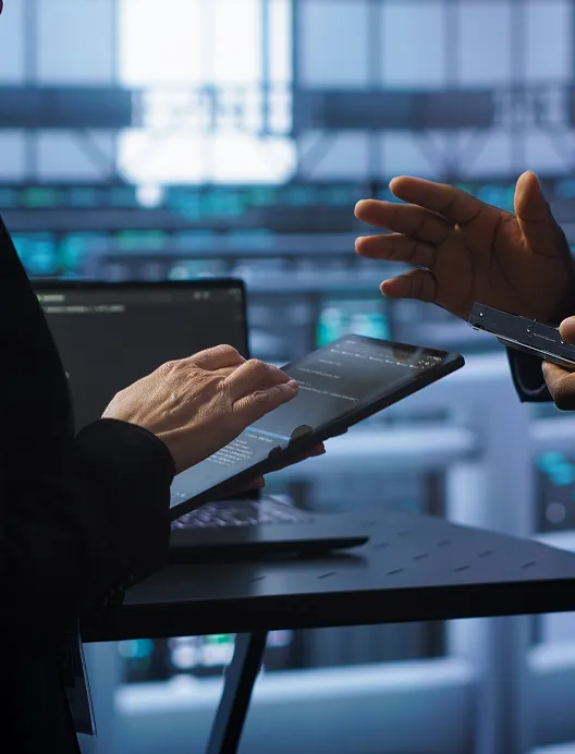 Hands using a tablet in a meeting
