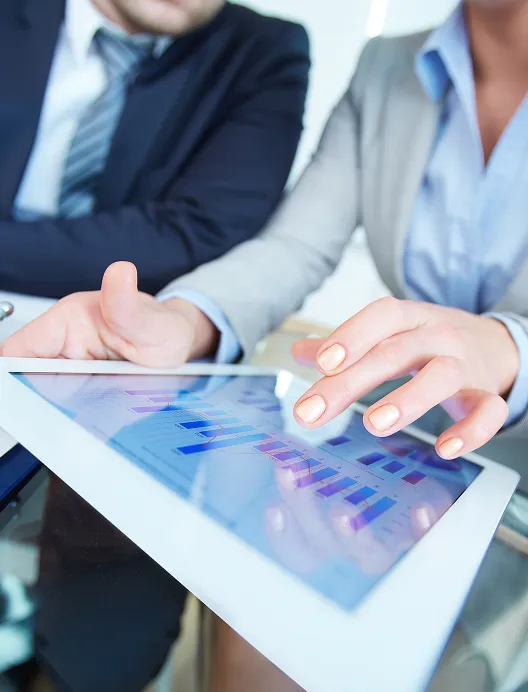 Hands reviewing charts on a tablet