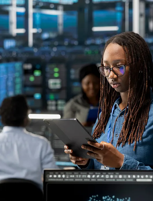 Woman using a tablet in a control room