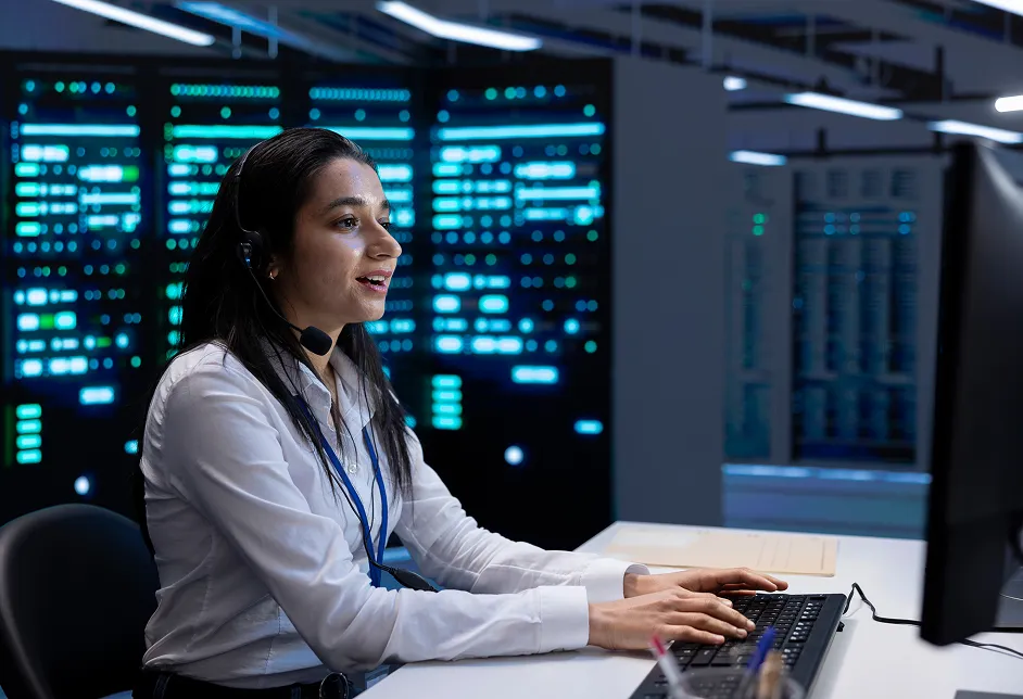 Woman at a computer in a data centre