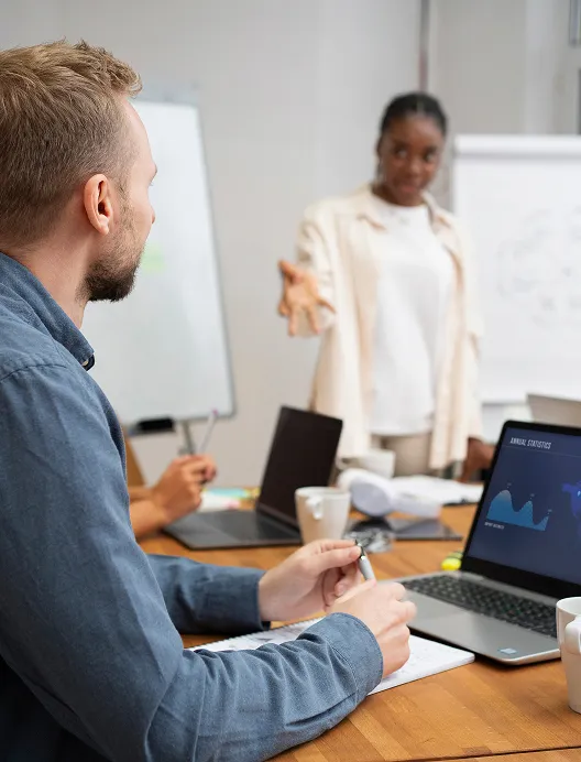 Man presenting to a colleague in a meeting