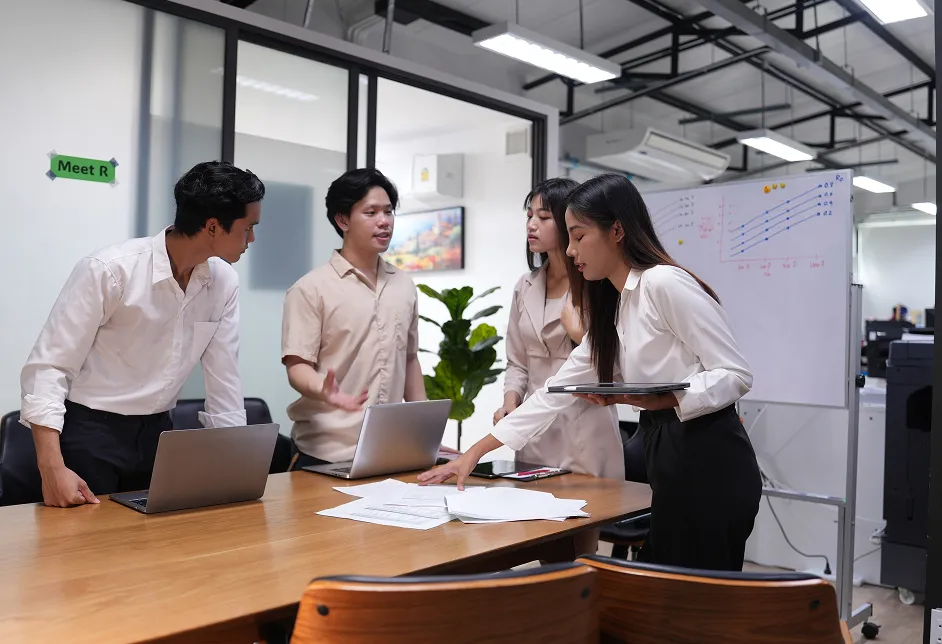 Team working with laptops in an office