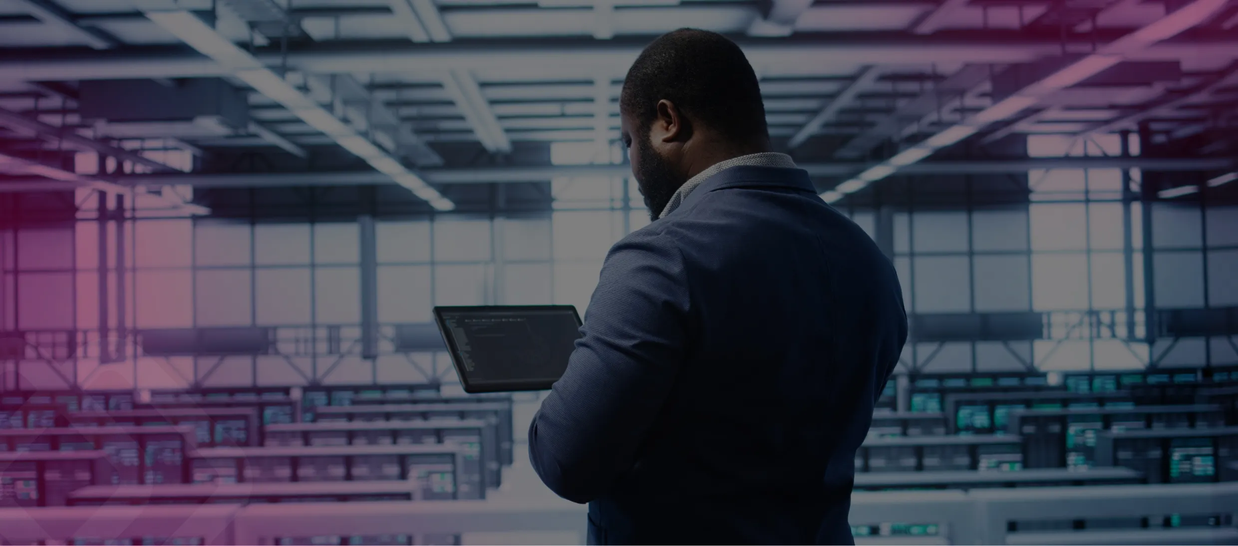 Man using a laptop in a data centre