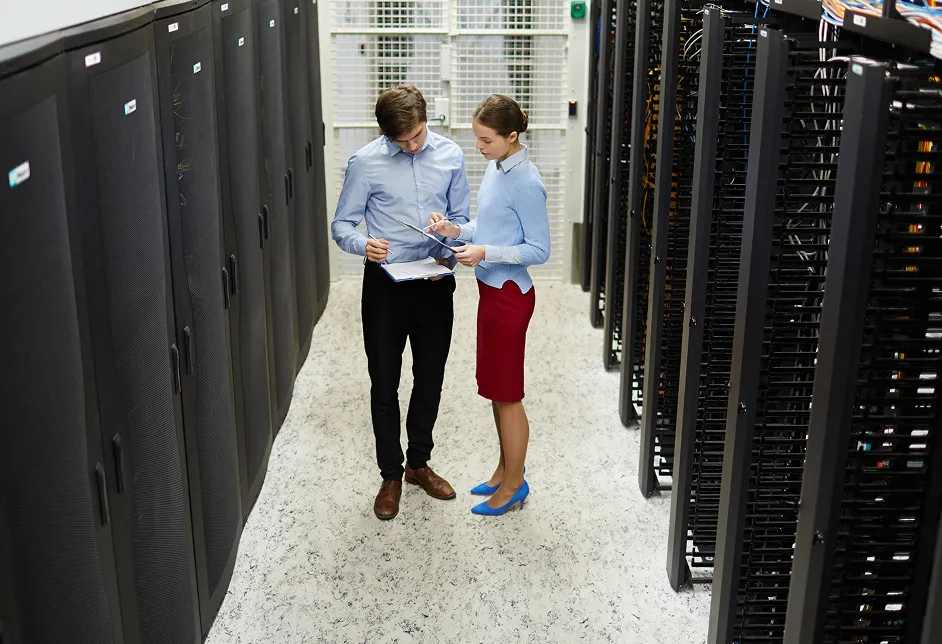Two colleagues talking in a server room