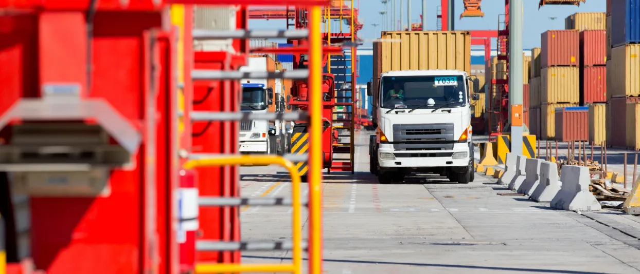 Truck at a loading bay beside industrial equipment