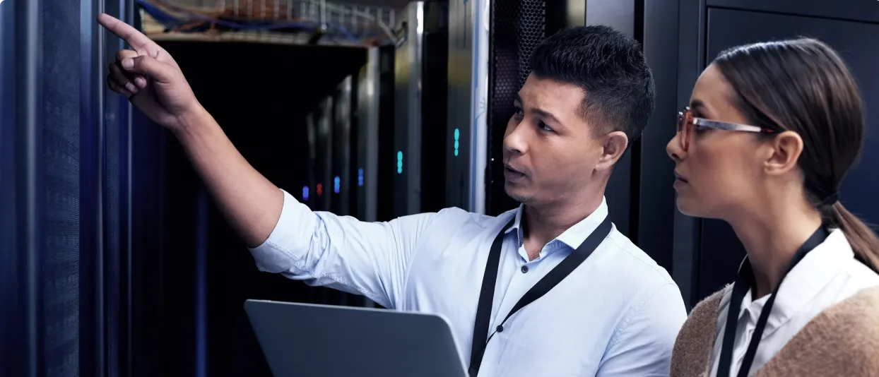 IT staff inspecting equipment in a server room