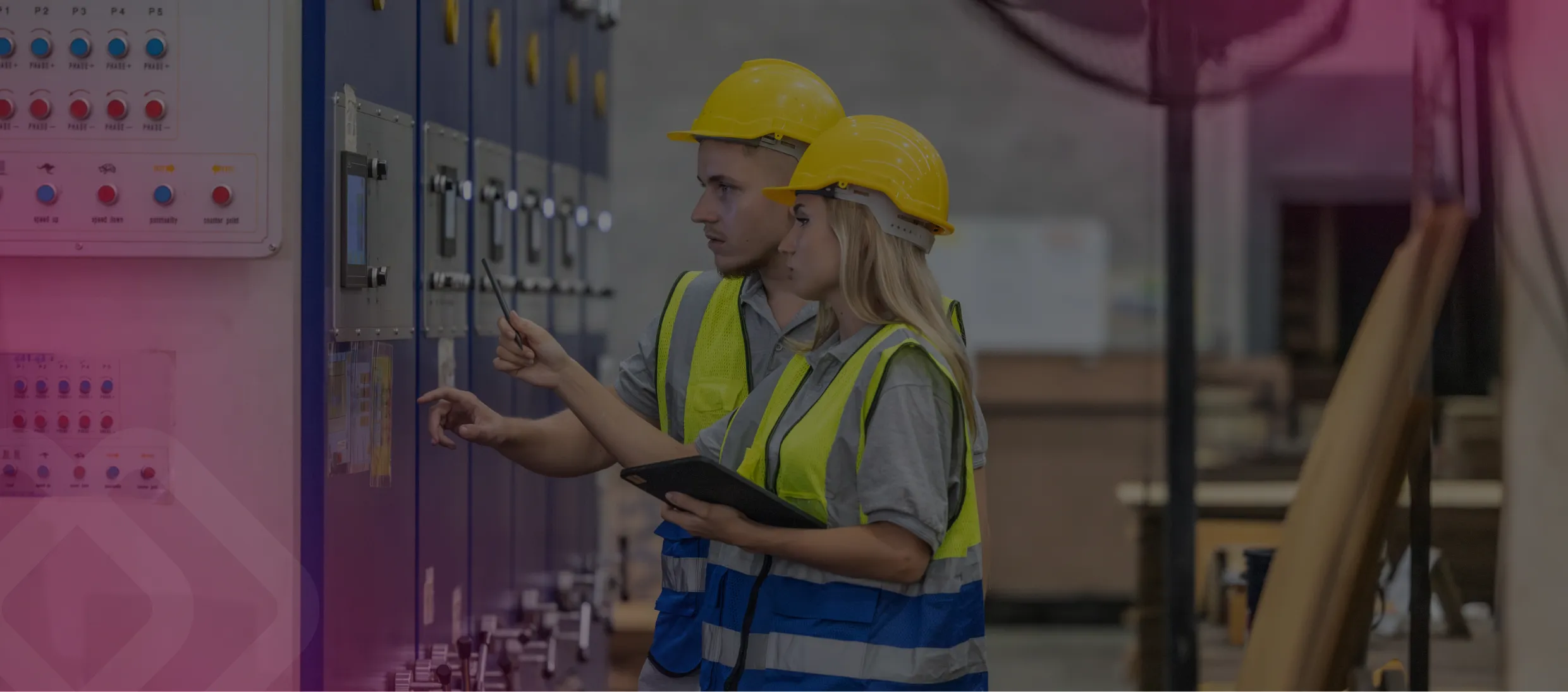 Worker in hi-vis at an electrical control panel