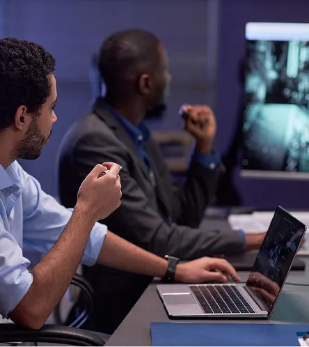 Two businessmen reviewing work on a laptop