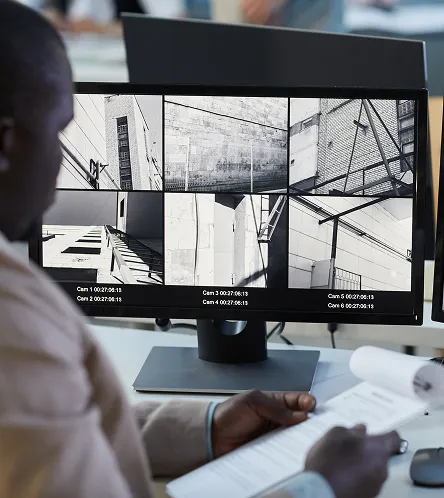 Person reviewing CCTV footage on a monitor
