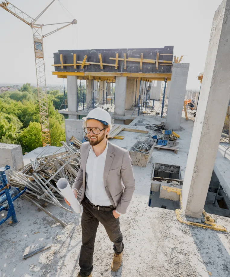 Man holding plans on a construction site
