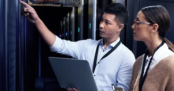 IT staff inspecting a server room