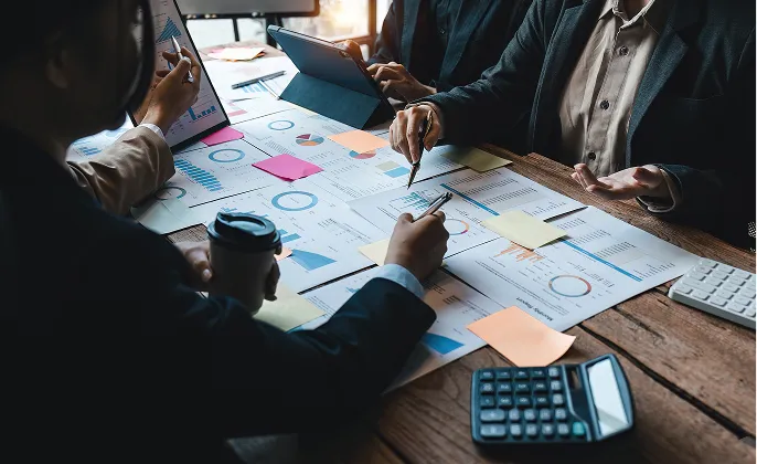 Team reviewing documents at a meeting