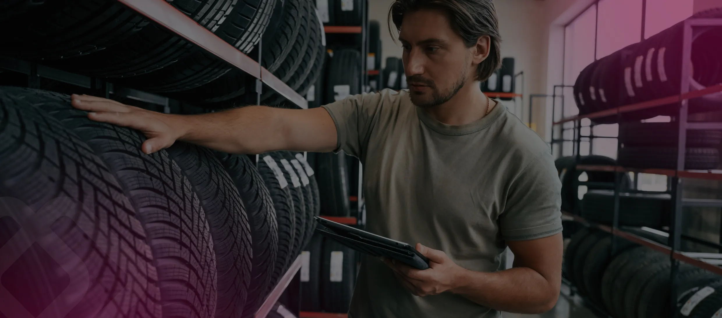 Worker checking tires with a tablet