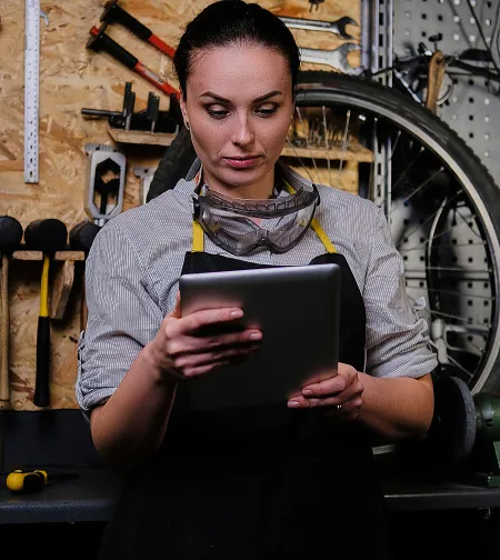 Woman mechanic using a tablet in a workshop