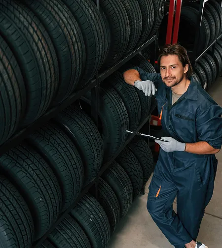Technician checking tires on a rack