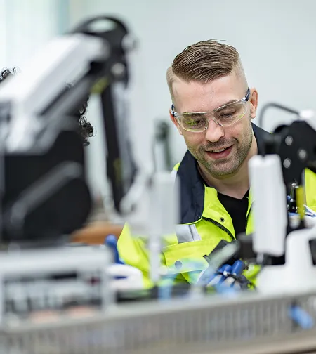 Technician working with a robotic arm