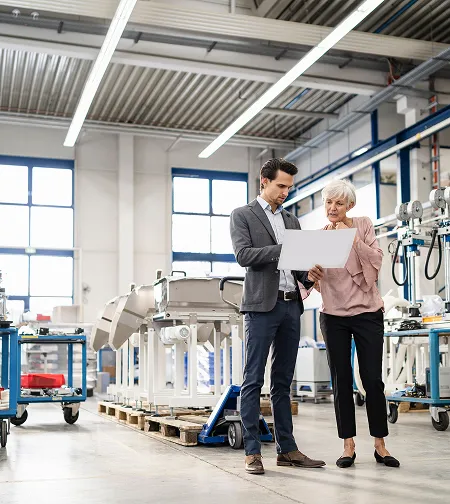 Two colleagues reviewing a document in a showroom