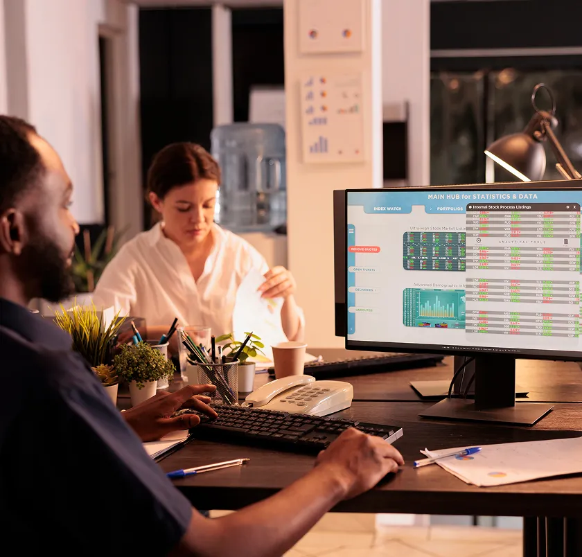 Colleagues reviewing a dashboard on a monitor in an office