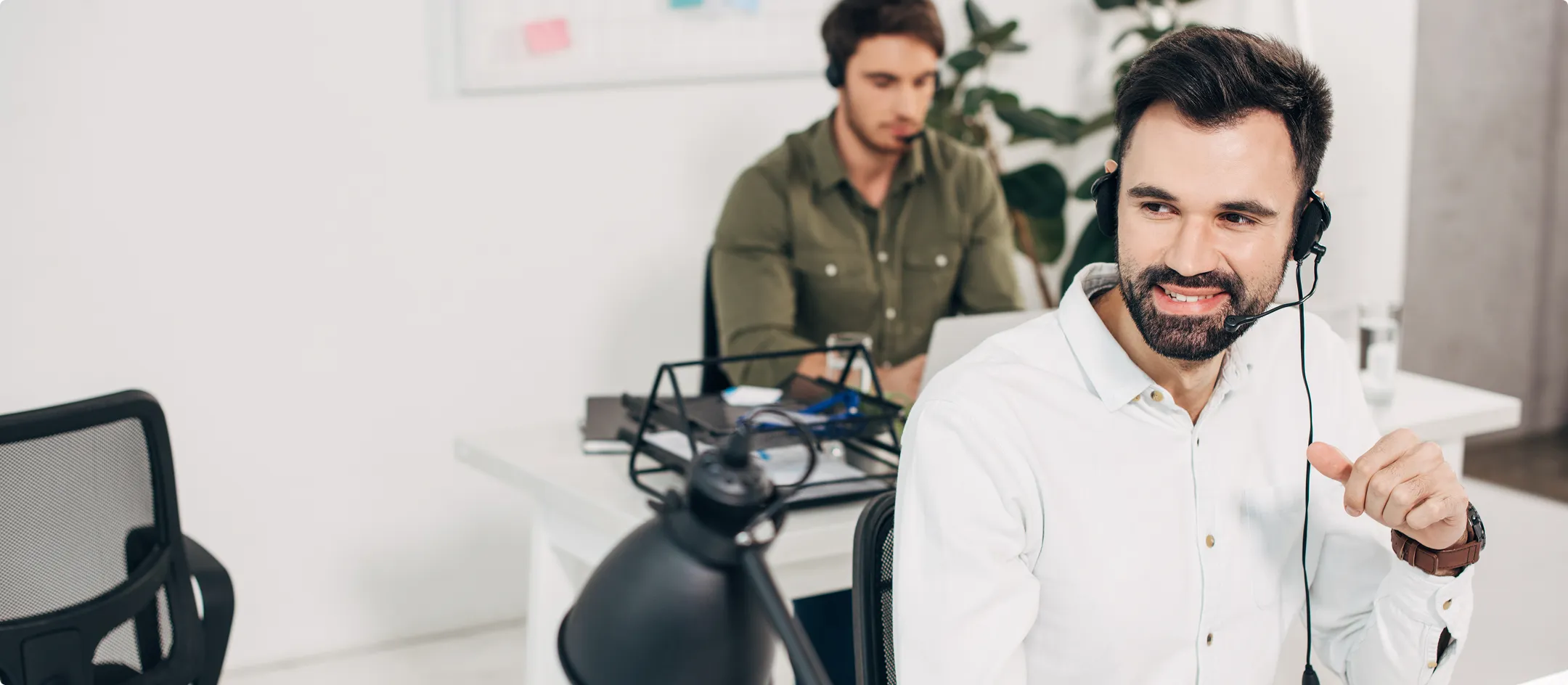 Support agent wearing a headset at a desk