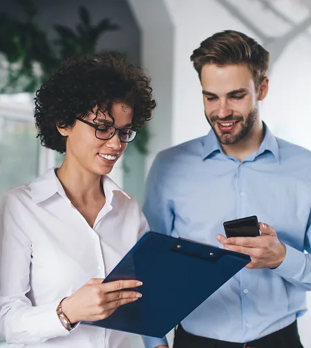 Two colleagues with a clipboard and phone