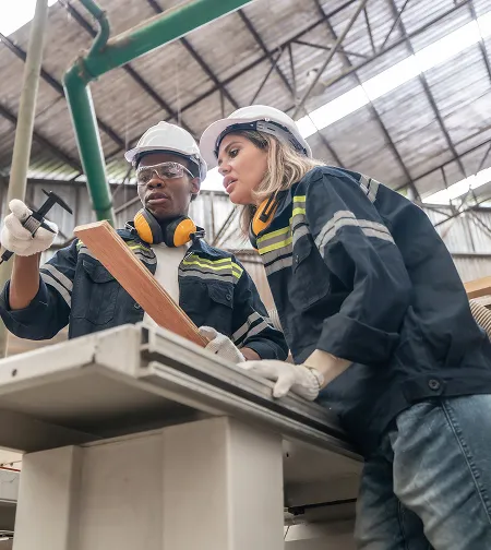 Two workers inspecting equipment on a bench