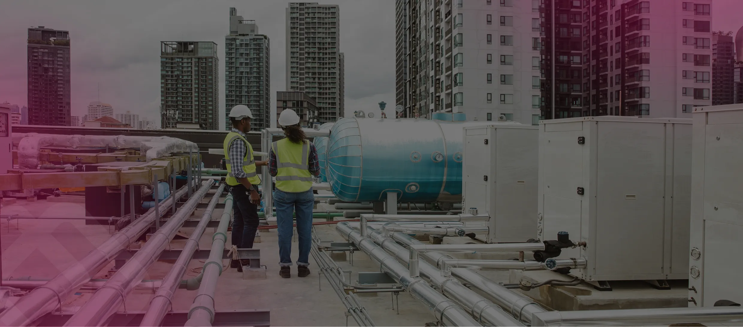 Workers inspecting rooftop HVAC units