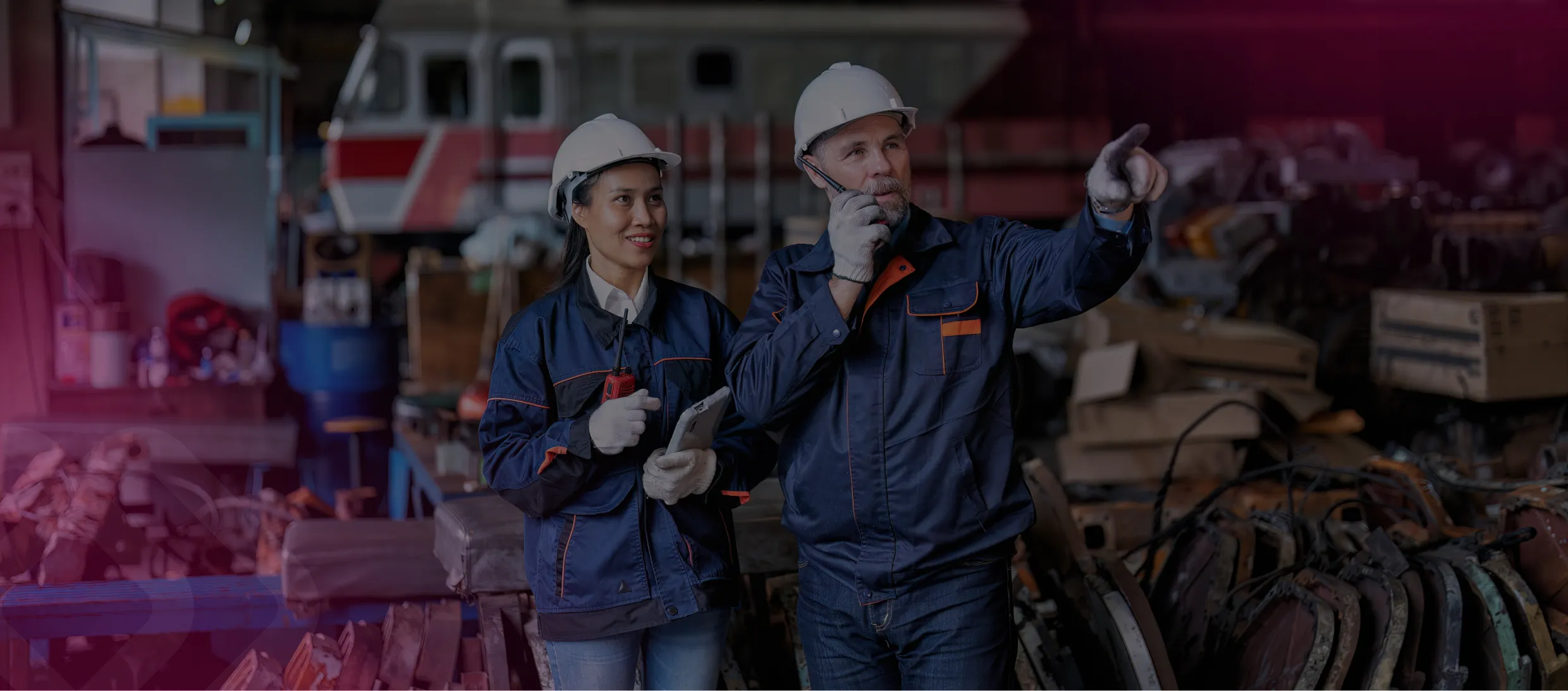 Two workers in hard hats handling cabling