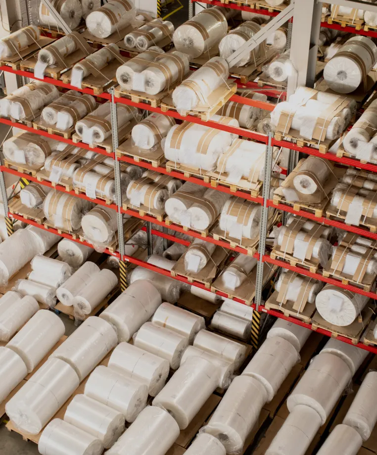 Rolls of material on warehouse racks