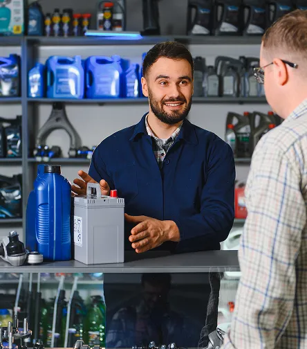 Salesperson showing a product to a customer in an auto parts store
