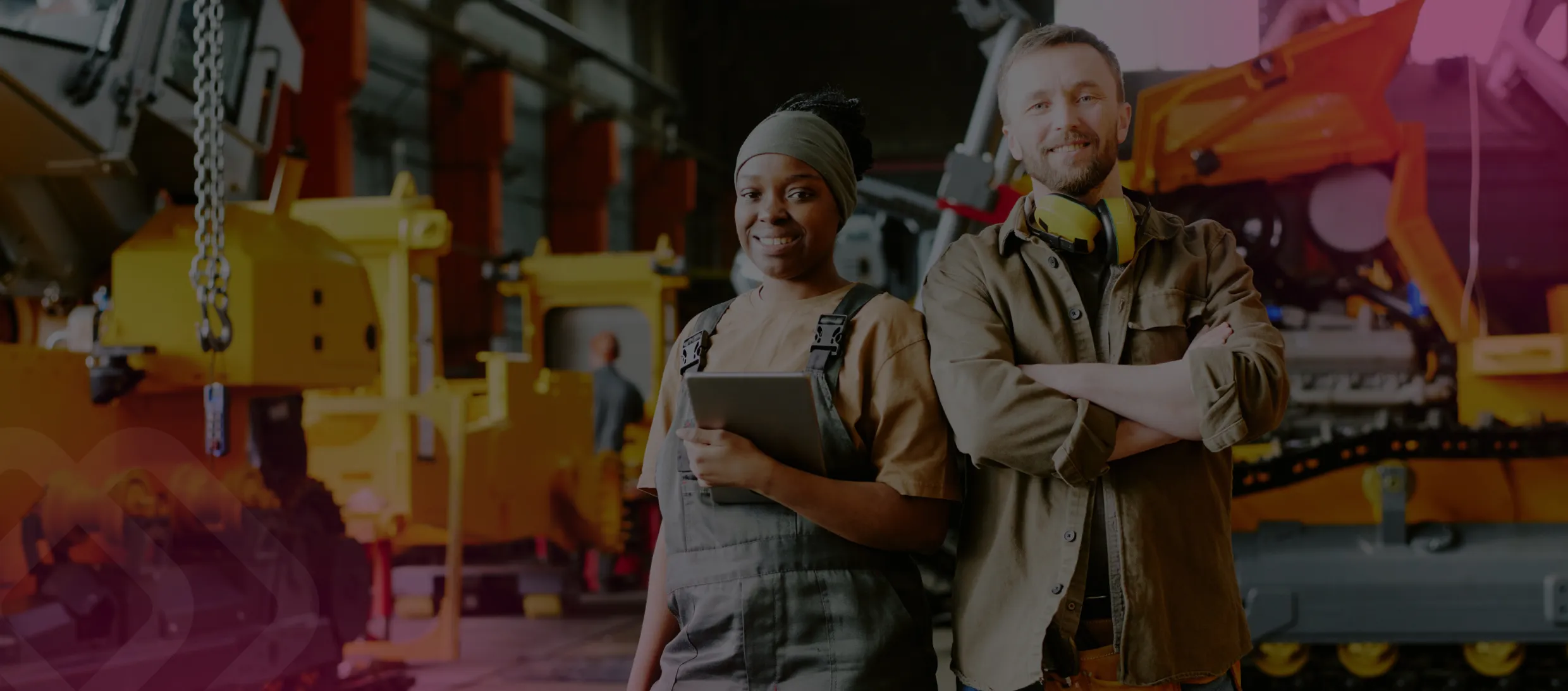 Two workers by lifting equipment