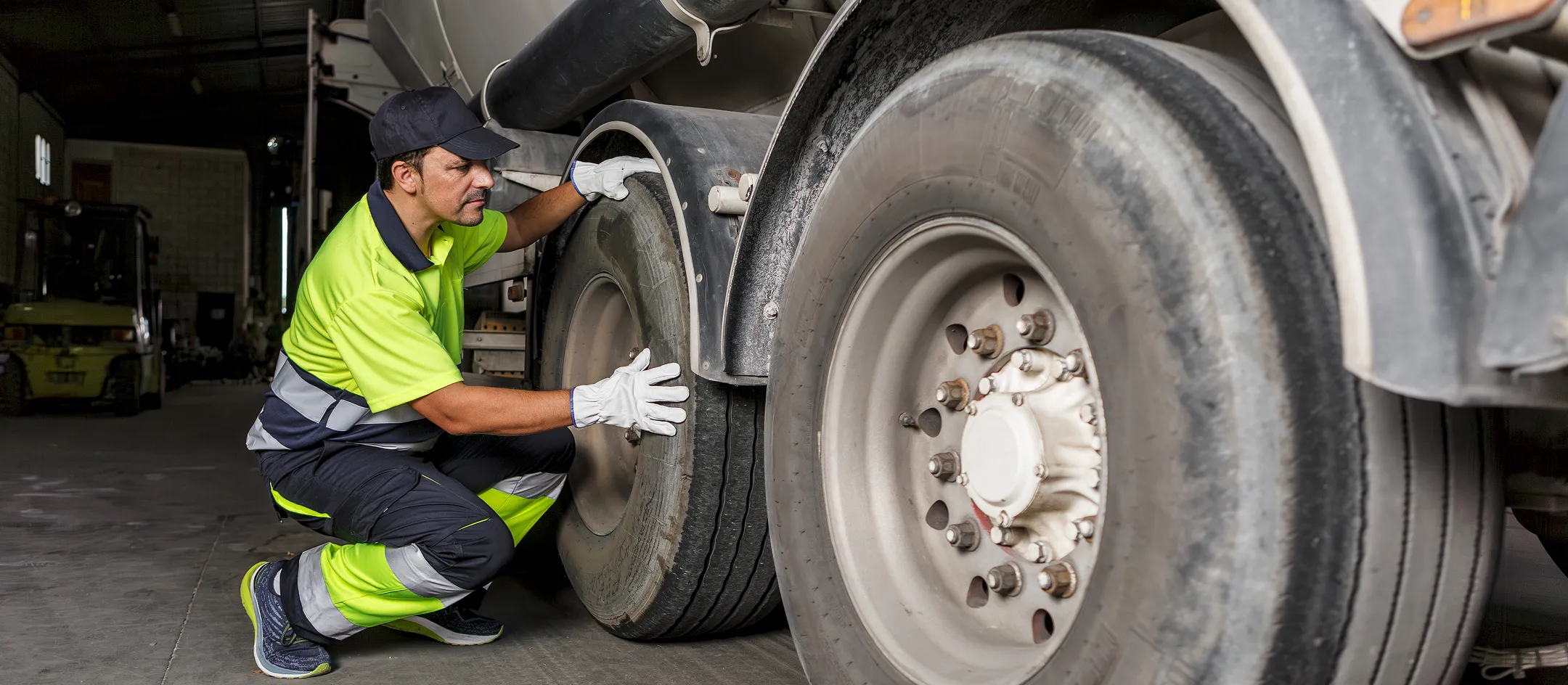 Mechanic inspecting a truck wheel